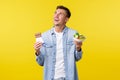 Healthy lifestyle, people and food concept. Happy dreamy smiling guy looking upper left corner while holding bowl with Royalty Free Stock Photo