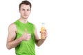 Healthy lifestyle. Portrait of a handsome guy with juice and a thumb up, in sportswear, isolated on a white background, looking at Royalty Free Stock Photo