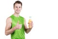 Healthy lifestyle. Portrait of a handsome guy with juice and a thumb up, in sportswear, isolated on a white background, looking at Royalty Free Stock Photo