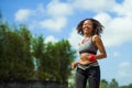 Healthy lifestyle portrait of young happy and fit Asian Chinese runner woman in running workout outdoors at green field background Royalty Free Stock Photo