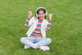 Healthy lifestyle and relax. Yoga girl. small kid in headphones. summer playlist. enjoy spring nature outdoor. child Royalty Free Stock Photo