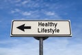 Healthy lifestyle road sign, arrow on blue sky background Royalty Free Stock Photo