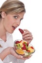 Healthy lifestyle series - Woman biting strawberry Royalty Free Stock Photo
