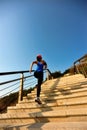 Healthy lifestyle sports woman running up on stone stairs sunrise Royalty Free Stock Photo