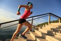 Healthy lifestyle sports woman running up on stone stairs sunrise Royalty Free Stock Photo