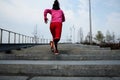 Healthy lifestyle sports woman running up on stone stairs at sunrise seaside Royalty Free Stock Photo