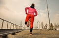 Healthy lifestyle sports woman running up on stone stairs at sunrise seaside Royalty Free Stock Photo