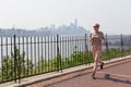 Healthy lifestyle. Woman is jogging on Hamilton ave by Hamilton park, New Jersey. Manhattan of New York City in the Royalty Free Stock Photo