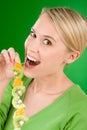 Healthy lifestyle - woman kiwi and orange on stick