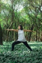 Healthy lifestyle for women practicing meditation and yoga in the forest. Young woman practicing yoga outdoors. Meditation concept Royalty Free Stock Photo