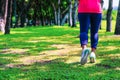 Healthy lifestyle woman runner jogging on beautiful summer day in the public green park. Fitness and workout wellness concept Royalty Free Stock Photo