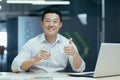 Healthy Lifestyle. A young Asian freelancer man drinks water in the office, maintains water balance Royalty Free Stock Photo