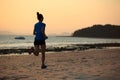 Fitness woman running at sunset beach Royalty Free Stock Photo