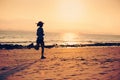 Young fitness woman running at sunset beach Royalty Free Stock Photo