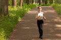 Healthy lifestyle. Young girl in headphones goes in for sports, runs