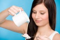 Healthy lifestyle - young woman pour milk cereal Royalty Free Stock Photo