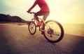 Young woman riding bike on seaside Royalty Free Stock Photo