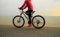 Young woman riding bike on seaside Royalty Free Stock Photo