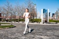 Young woman is running in Liberty State Park. Run in the city