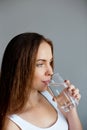 Healthy lifestyle. Young woman show glass of water. Girl drinks water. Royalty Free Stock Photo