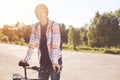 Healthy lifstyle. Portrait of active and sport teenager on bike ride standing on asphalt outdoor. Young male having calm holiday t