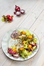 Healthy light salad with fried mozzarella cheese, fresh vegetables and crispy mix salad with lemon honey dressing and cranberry Royalty Free Stock Photo