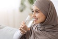 Healthy Liquid. Smiling Muslim Woman Drinking Mineral Water From Glass At Home, Royalty Free Stock Photo