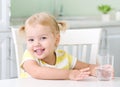 Healthy little child girl portrait with glass of water