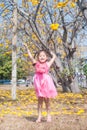 Healthy Little cute girl in pink dress with yellow flowers. Royalty Free Stock Photo