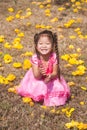 Healthy Little cute girl in pink dress with yellow flowers. Royalty Free Stock Photo