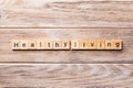 Healthy Living word written on wood block. Healthy Living text on wooden table for your desing, concept Royalty Free Stock Photo