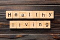 Healthy Living word written on wood block. Healthy Living text on wooden table for your desing, concept Royalty Free Stock Photo