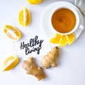 HEALTHY LIVING - written on piece of paper among the products for the treatment of common cold - lemon, ginger, chamomile tea.