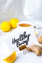 HEALTHY LIVING - written on piece of paper among the products for the treatment of common cold - lemon, ginger