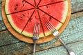Healthy low calorie vegan dessert. Fresh watermelon cut like pizza on round bamboo board Royalty Free Stock Photo