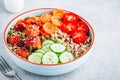 Healthy lunch bowl with quinoa, meatballs cucumbers, carrots and pumpkin seeds