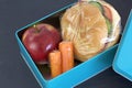 Healthy lunch box, cheese sandwich, apple and carrots