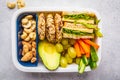 Healthy lunch box with sandwich, cookies, fruits and avocado on white background Royalty Free Stock Photo