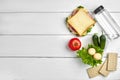 Healthy lunch box with sandwich, eggs and fresh vegetables, bottle of water on rustic wooden background. Top view with Royalty Free Stock Photo