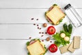 Healthy lunch box with sandwiches, eggs and fresh vegetables, bottle of water and nuts on rustic wooden background. Top Royalty Free Stock Photo