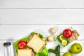 Healthy lunch box with sandwiches, eggs and fresh vegetables, bottle of water on rustic wooden background. Top view with Royalty Free Stock Photo