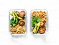 Healthy lunch box - spicy couscous with chickpeas, broccoli, green beans and turkey meatballs on dark background, top view.