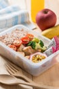 Healthy lunch boxes in plastic package, Grilled chicken breast with broccoli, tomato and passion fruit, dragon fruit. Diet food Royalty Free Stock Photo