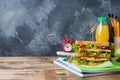 Healthy lunch for school with sandwich, fresh apple and orange juice. Assorted colorful school supplies. Copy space Royalty Free Stock Photo