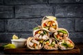 Healthy lunch snack. Stack of mexican street food fajita tortilla wraps with grilled buffalo chicken fillet and fresh Royalty Free Stock Photo