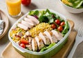 A healthy lunch in a thermos. Mini salad of vegetables - cucumbers, tomatoes, carrots, lettuce, corn, nuts and chicken Royalty Free Stock Photo