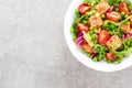 Healthy lunch vegetable salad with baked salmon fish, fresh green peas, lettuce and tomato