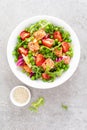 Healthy lunch vegetable salad with baked salmon fish, fresh green peas, lettuce and tomato