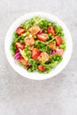 Healthy lunch vegetable salad with baked salmon fish, fresh green peas, lettuce and tomato