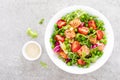 Healthy lunch vegetable salad with baked salmon fish, fresh green peas, lettuce and tomato